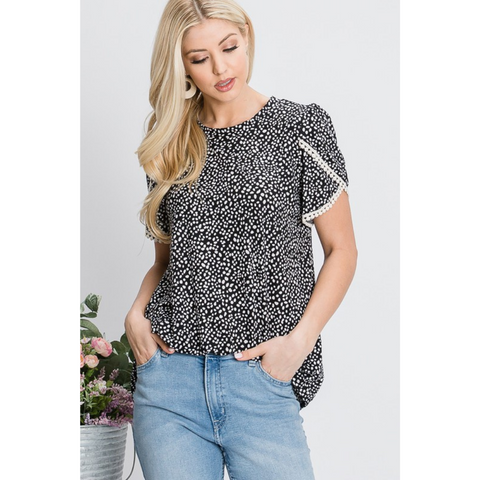 black tulip sleeve top with white spotted pattern and lace trim