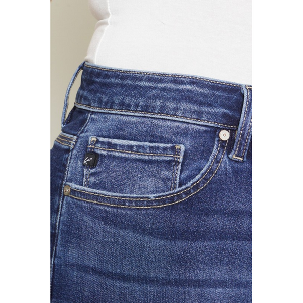 close up of pocket and tag of denim bermuda shorts with button fly