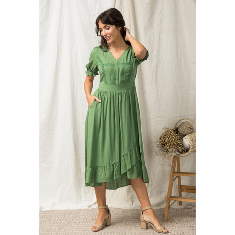 green dress with pleated bodice and lace inserts