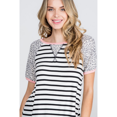 cream and black striped top with leopard prind sleeves and pink trim on neck and sleeves.